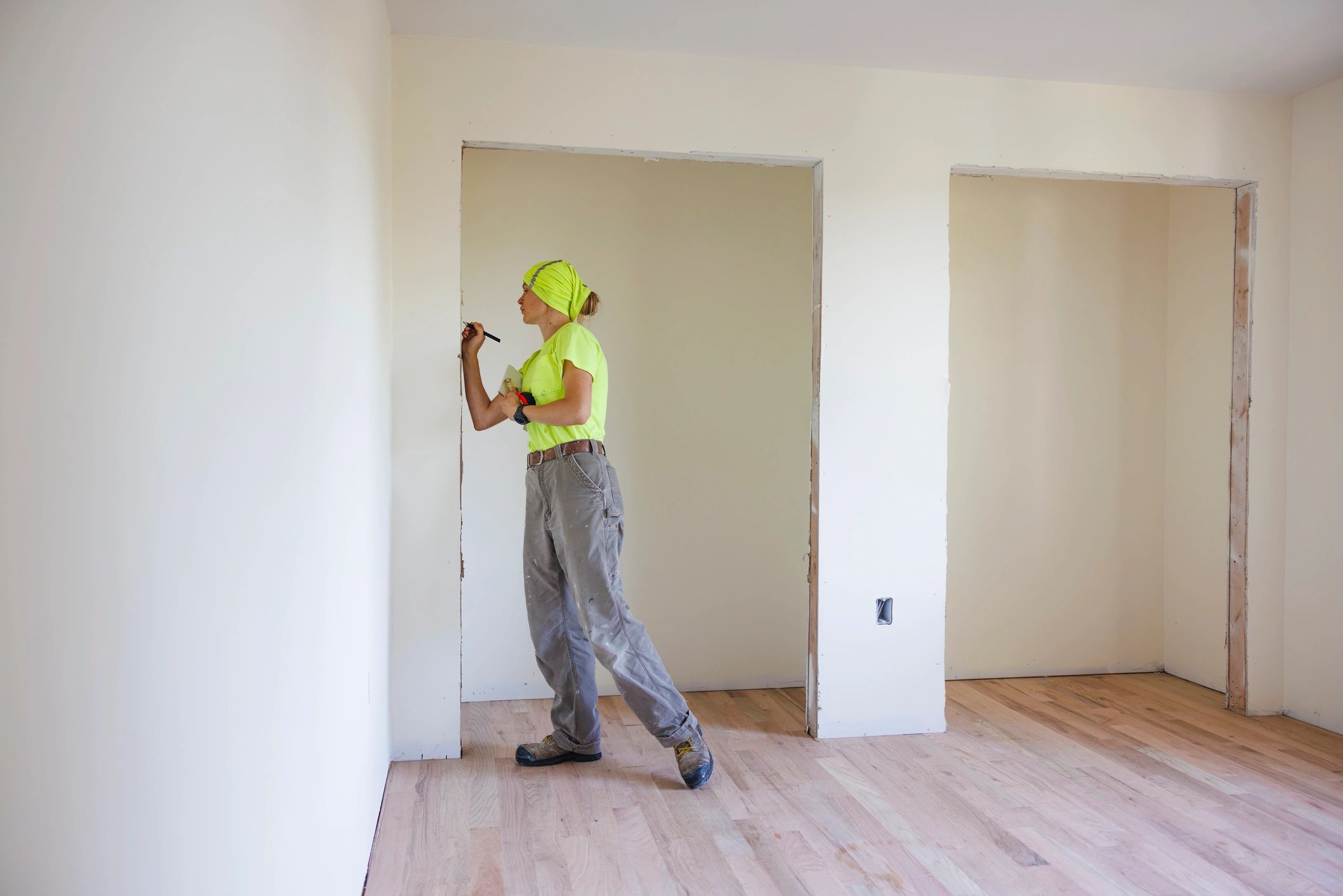 Contractor measuring a doorway for repair planning